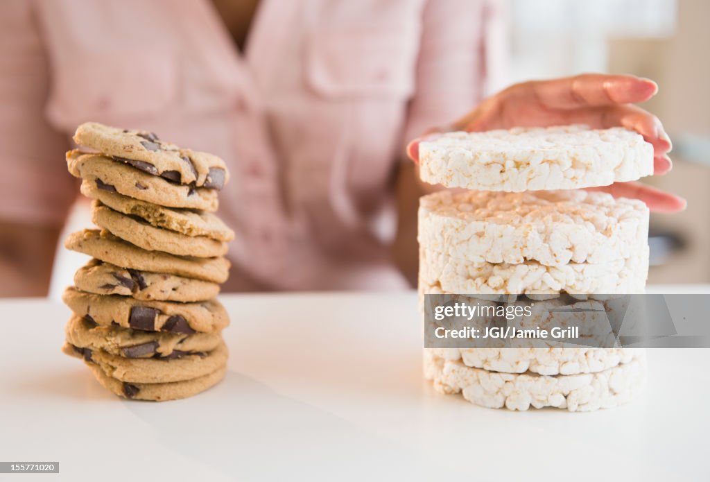 Cape Verdean woman stacking cookies and rice cakes