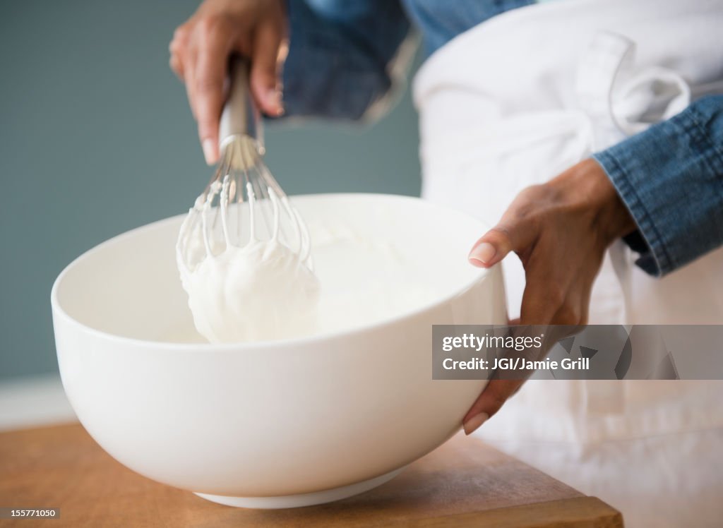 Cape Verdean woman whisking cream
