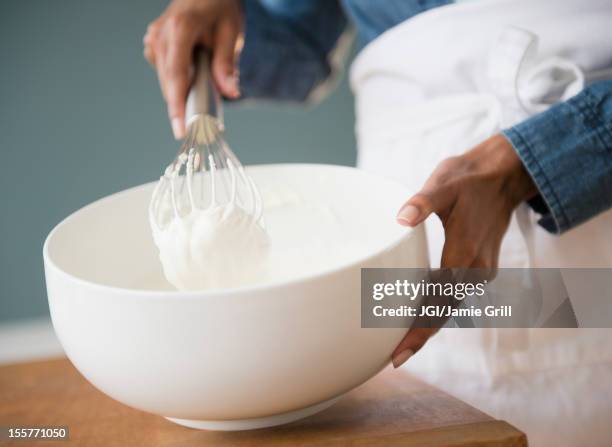 cape verdean woman whisking cream - frusta foto e immagini stock