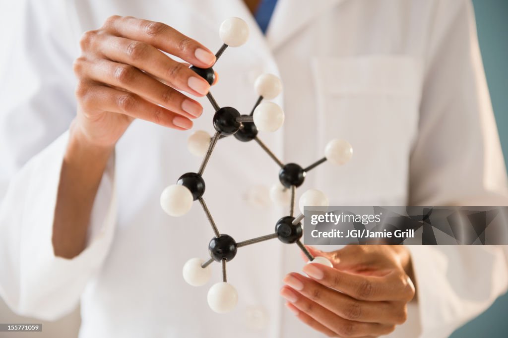 Cape Verdean scientist holding molecule model