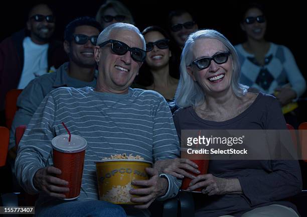 senior couple watching 3d movie - amour 2012 film stock pictures, royalty-free photos & images