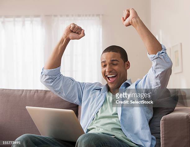young adult male with hands raised - celebrate yourself bildbanksfoton och bilder