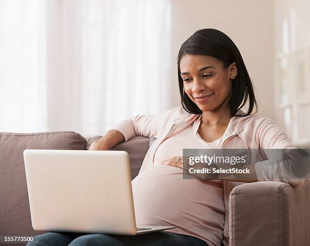 pregnant woman making online purchase - one woman only videos stock pictures, royalty-free photos & images