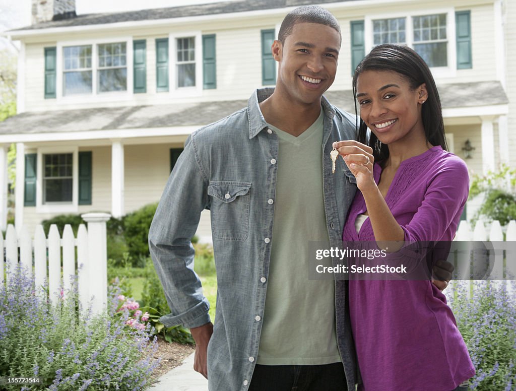Young couple with keys to new home