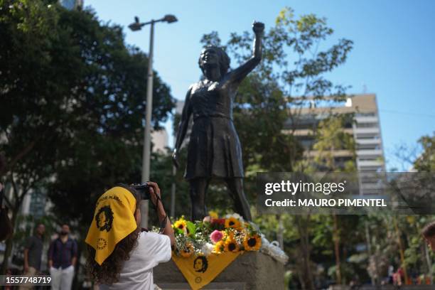 Child takes a picture of a statue of slain Brazilian rights activist and politician Marielle Franco at the Buraco do Lume in Rio de Janeiro, Brazil...