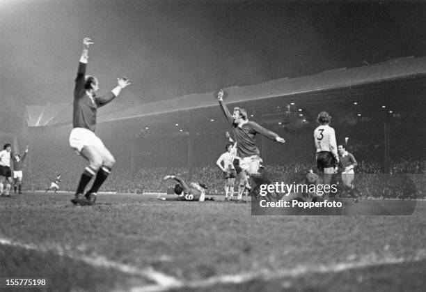 Scottish footballer Dennis Law of Manchester United, celebrates a goal, circa 1970. On the left is teammate Bobby Charlton.