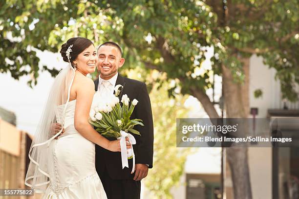 smiling hispanic bride and groom - wedding planning foto e immagini stock