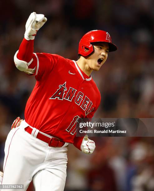 Shohei Ohtani of the Los Angeles Angels reacts after hitting a two-run home run against the New York Yankees in the seventh inning at Angel Stadium...