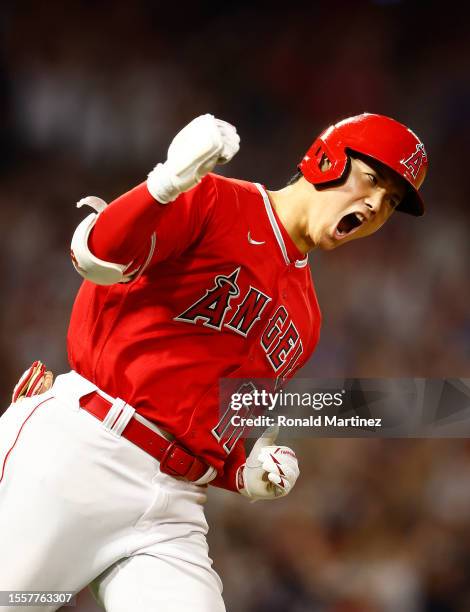 Shohei Ohtani of the Los Angeles Angels reacts after hitting a two-run home run against the New York Yankees in the seventh inning at Angel Stadium...