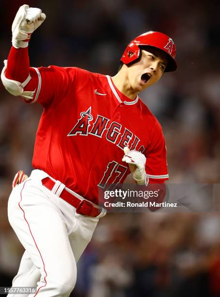 Shohei Ohtani of the Los Angeles Angels reacts after hitting a two-run home run against the New York Yankees in the seventh inning at Angel Stadium...