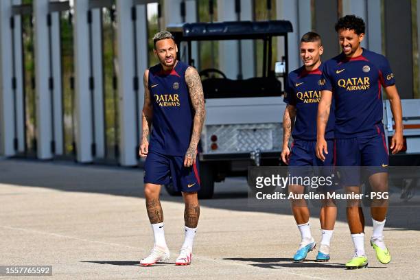 Neymar Jr, Marco Verratti and Marquinhos arrive on the pitch for a the Paris Saint-Germain training session at PSG Campus on July 20, 2023 in Poissy,...