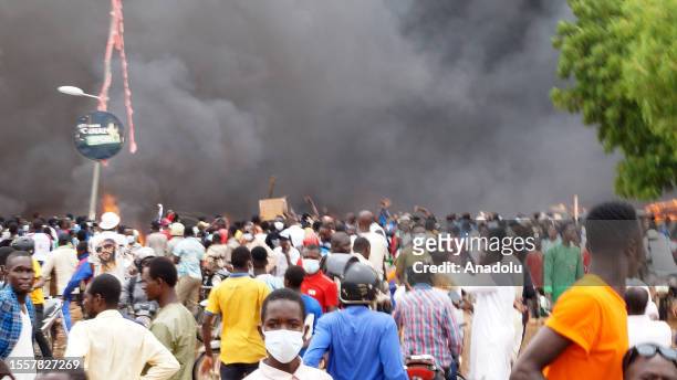 Smoke rises after coup supporters set fire to the headquarters of President Mohamed Bazoum's party, the Party for Democracy and Socialism in Niger in...