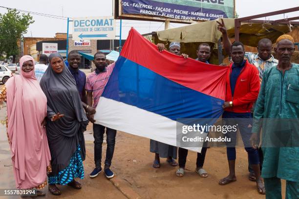 Coup supporters unfurl a Russian flag as they take to the streets after the army seized power in Niamey, Niger on July 27, 2023. The Nigerien...