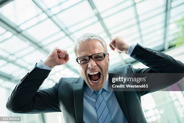 germany, stuttgart, businessman laughing in office building - stubble imagens e fotografias de stock