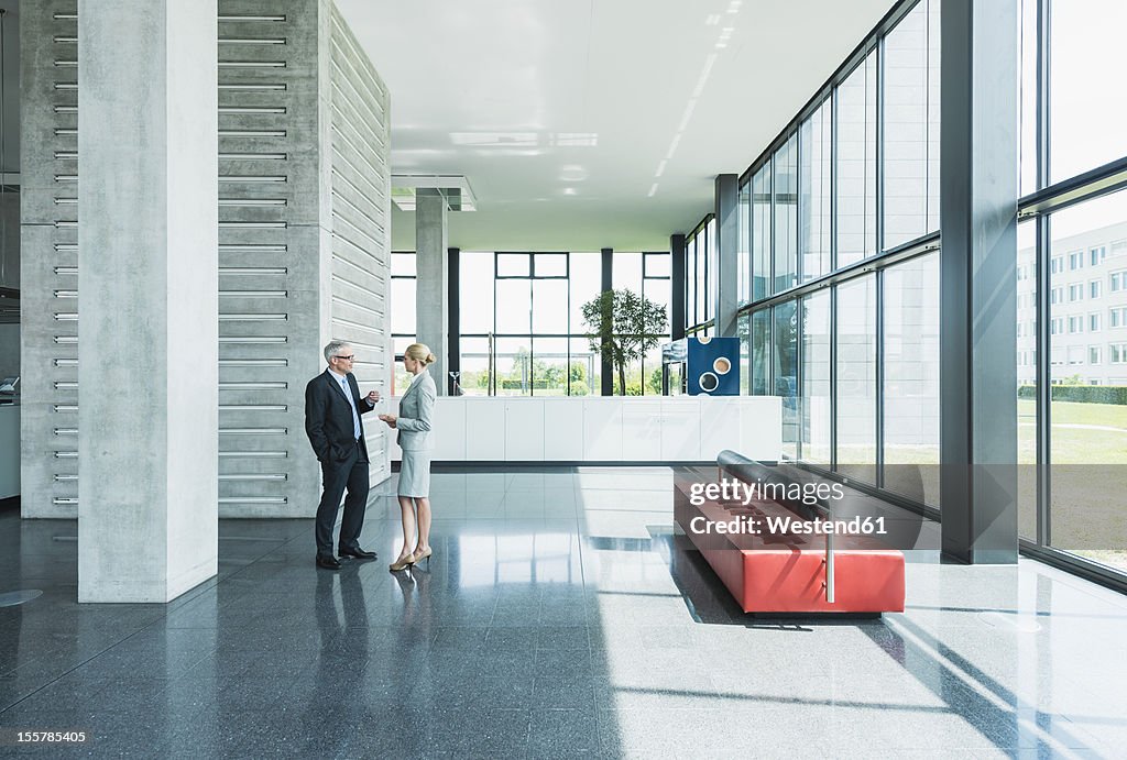 Germany, Stuttgart, Business people having discussion at office lobby