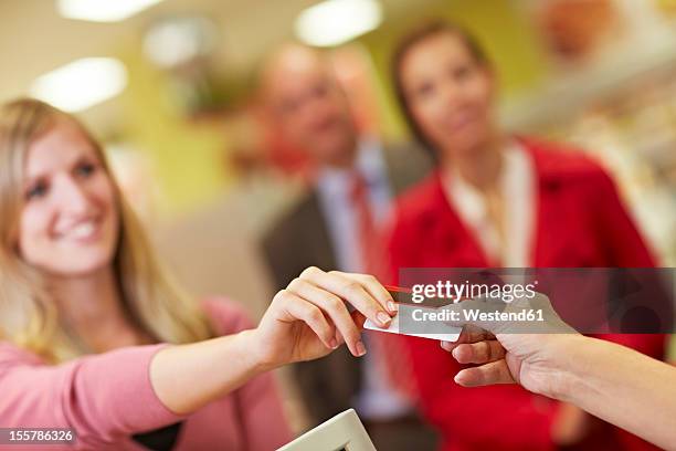 germany, cologne, people using credit card in supermarket - debit cards credit cards accepted stock pictures, royalty-free photos & images