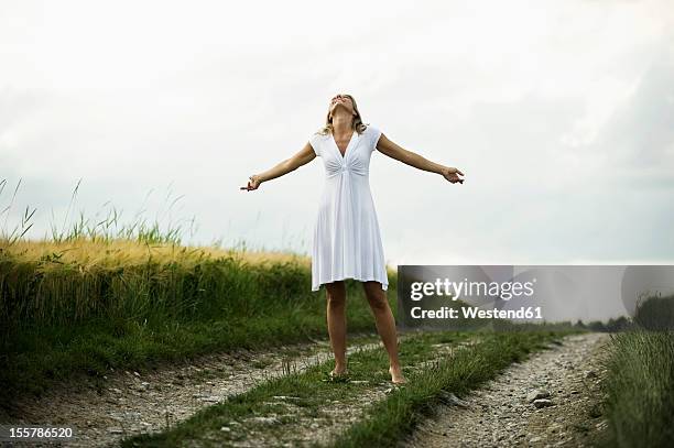 germany, bavaria, mature woman standing in grain field - head back stock pictures, royalty-free photos & images