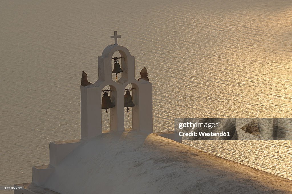Greece, Bell Tower of whitewashed church and sea in background Imerovigli at Santorini