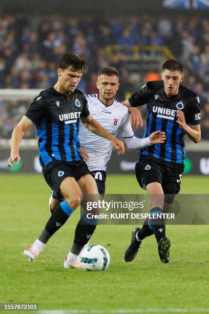 Club's Dutch defender Bjorn Meijer, Aarhus' Danish midfielder Mikkel Duelund and Club's Belgian defender Jorne Spileers fight for the ball during the...