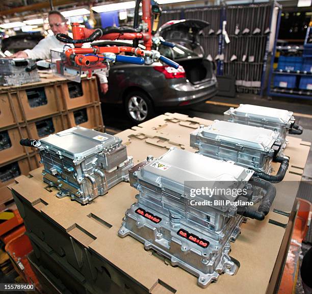 Ford worker installs components for electric, hybrid and plug-in hybrid vehicles at the Michigan Assembly Plant November 8, 2012 in Wayne, Michigan....