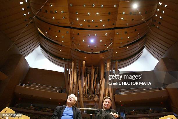 Finnish musician and composer Esa-Pekka Salonen speaks to reporters as architect Frank Gehry looks on at the main auditorium of the newly opened...