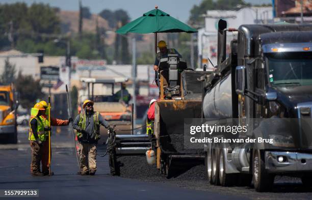 Woodland Hills, CA Heat radiates up off fresh asphalt as LA City street services workers lay down new pavement on Ventura Blvd. On Thursday, July 27,...