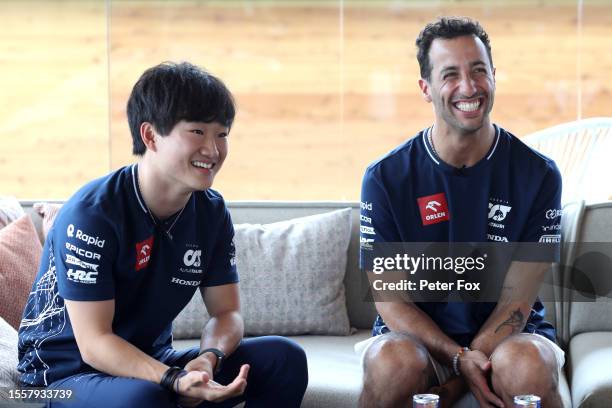Yuki Tsunoda of Japan and Scuderia AlphaTauri and Daniel Ricciardo of Australia and Scuderia AlphaTauri talk to the media in the Paddock during...