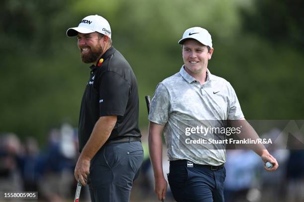 Robert MacIntyre of Scotland and Shane Lowry of Ireland interact during Day One of The 151st Open at Royal Liverpool Golf Club on July 20, 2023 in...