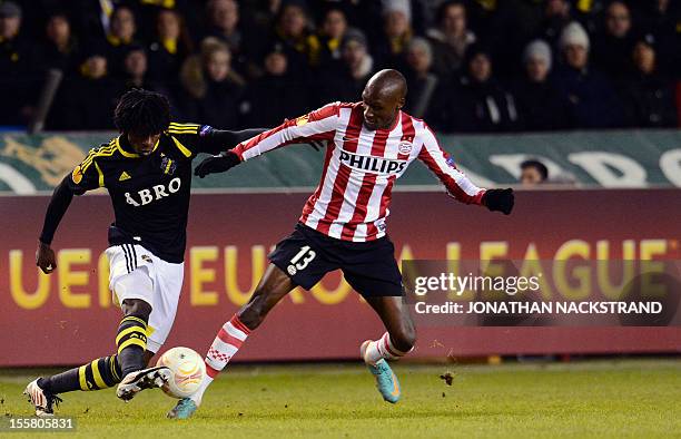 Eindhoven's midfielder Atiba Hutchinson vies for the ball with AIK Solna's striker Mohamed Bangura during the UEFA Europa League Group F football...