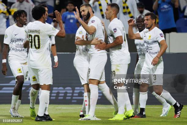 Ittihad's French forward Karim Benzema celebrates with teammates after scoring his team's second goal during the 2023 Arab Club Champions Cup group A...