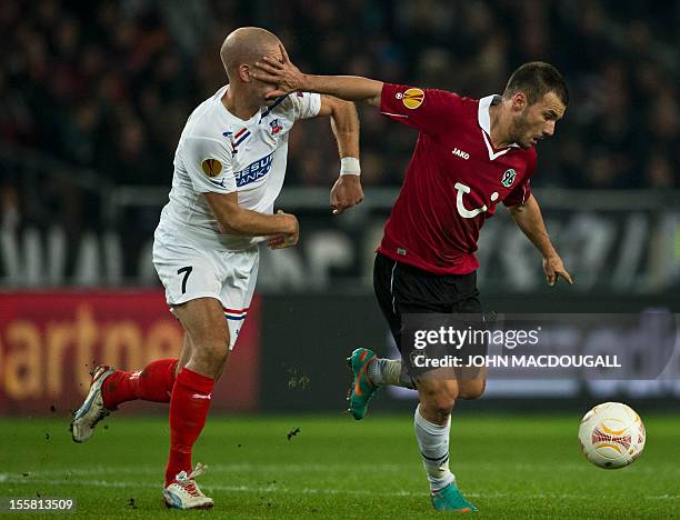 Hanover's Hungarian midfielder Szabolcs Huszti and Helsingborg's midfielder Mattias Lindstroem vie for the ball during the UEFA Europa League Group L...