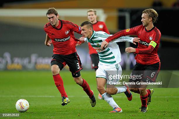 Dominik Wydra of Wien is challenged by Stefan Reinartz and Simon Rolfes of Leverkusen during the UEFA Europa League Group K match between Bayer 04...