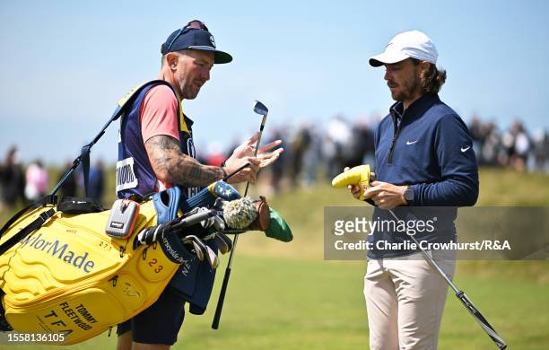 Tommy Fleetwood of England looks on alongside caddy Ian Finnis during Day One of The 151st Open at Royal Liverpool Golf Club on July 20, 2023 in...
