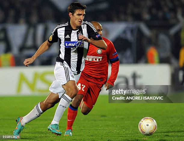 Partizan Belgrade's Stefan Scepovic controls the ball in front of Inter Milan's Jonathan during the UEFA Europa League group H football match...