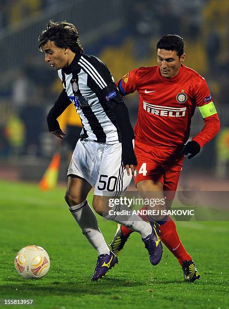 Partizan Belgrade's Lazar Markovic vies for the ball with Inter Milan's Javier Zanetti during the UEFA Europa League group H football match Partizan...