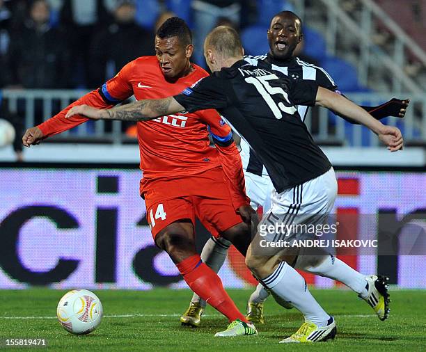 Inter Milan's Fredy Guarin vies for the ball with Partizan Belgrade's Ivan Ivanov and Medo during the UEFA Europa League group H football match...