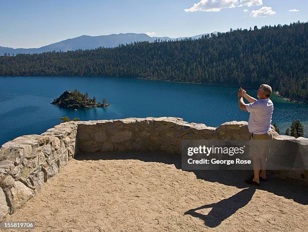 Man takes pictures of Emerald Bay on September 28 in South Lake Tahoe, California. Lake Tahoe, straddling the border of California and Nevada, is the...