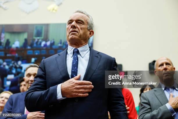 Democratic presidential candidate Robert F. Kennedy Jr. Holds his hand over his heart during the pledge of allegiance before the start of a hearing...