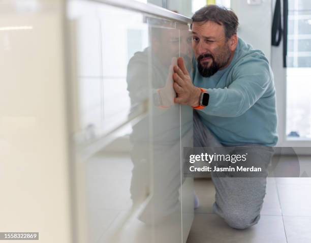 man checking level surface indoors - counter surface level stock pictures, royalty-free photos & images