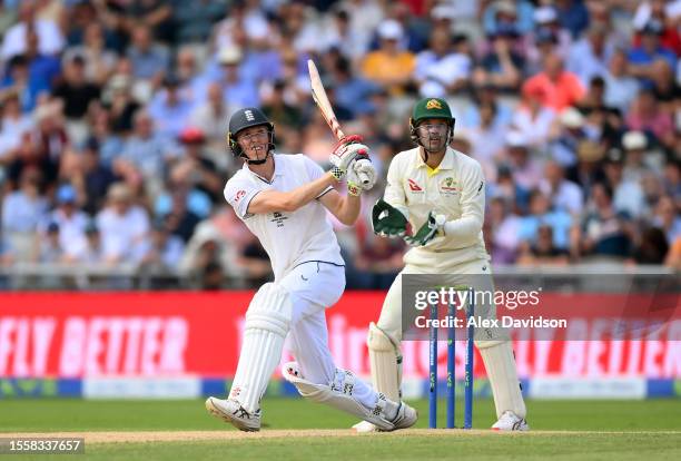 Zak Crawley of England hits a boundary as Alex Carey of Australia looks on during Day Two of the LV= Insurance Ashes 4th Test Match between England...