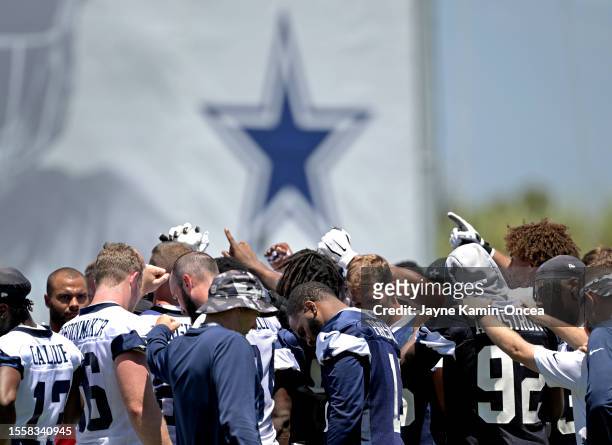 Dallas Cowboy players huddle during training camp at River Ridge Playing Fields on July 27, 2023 in Oxnard, California.