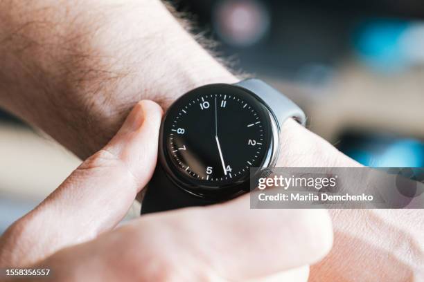 smart watch on male hands - wrist stock pictures, royalty-free photos & images
