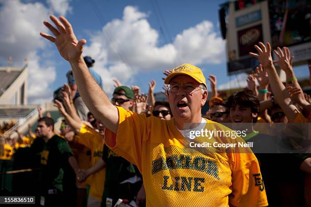 Baylor University President Ken Starr cheers with students prior to kickoff against the University of Kansas Jayhawks on November 3, 2012 at Floyd...