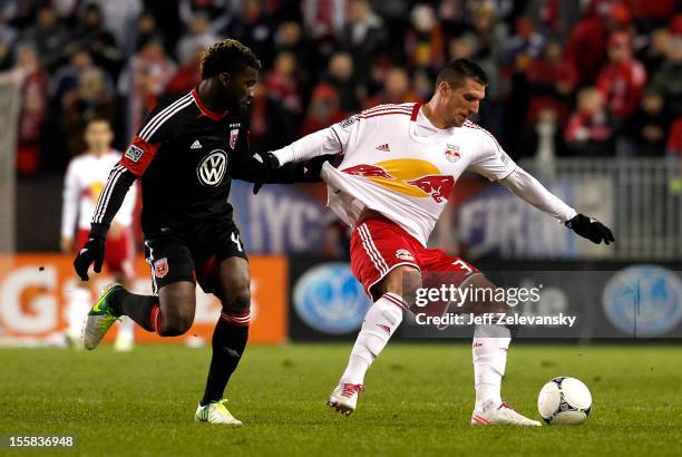 Kenny Cooper of New York Red Bulls fights for the ball with Brandon McDonald of D.C. United in their Eastern Conference Semifinal match at Red Bull...