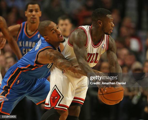 Eric Maynor of the Oklahoma City Thunder reaches in to try and knock the ball away from Nate Robinson of the Chicago Bulls at the United Center on...