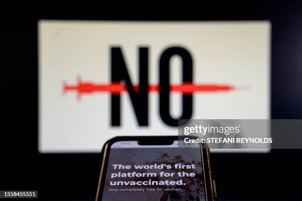 This photo illustration created in Washington, DC, on July 26 shows the homepage of "Unjected," a dating platform for unvaccinated people, in front...