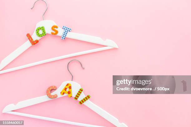 white hangers with sale text on pink background,pula,croatia - editorial template stock pictures, royalty-free photos & images