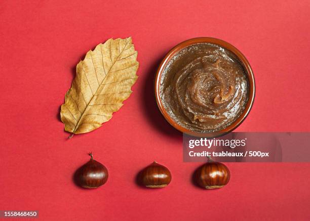 chestnut cream on a red background,france - chataigne stock pictures, royalty-free photos & images