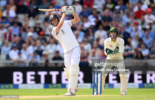 Zak Crawley of England hits a boundary as Alex Carey of Australia looks on during Day Two of the LV= Insurance Ashes 4th Test Match between England...