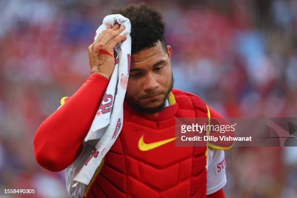 Willson Contreras of the St. Louis Cardinals leaves the game after being hit in the head by a bat in the first inning of a game against the Chicago...
